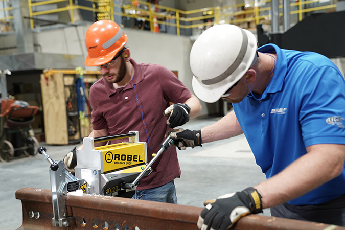 Engineer II Caleb Rogers, left, and Senior Engineer II Zach Dombrow test rail drills. BNSF's Strategic Sourcing Department sent several drills for testing and comparison.